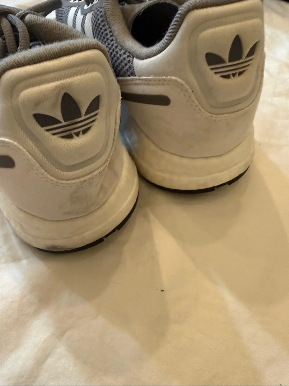 adidas gray and cream athletic shoe.